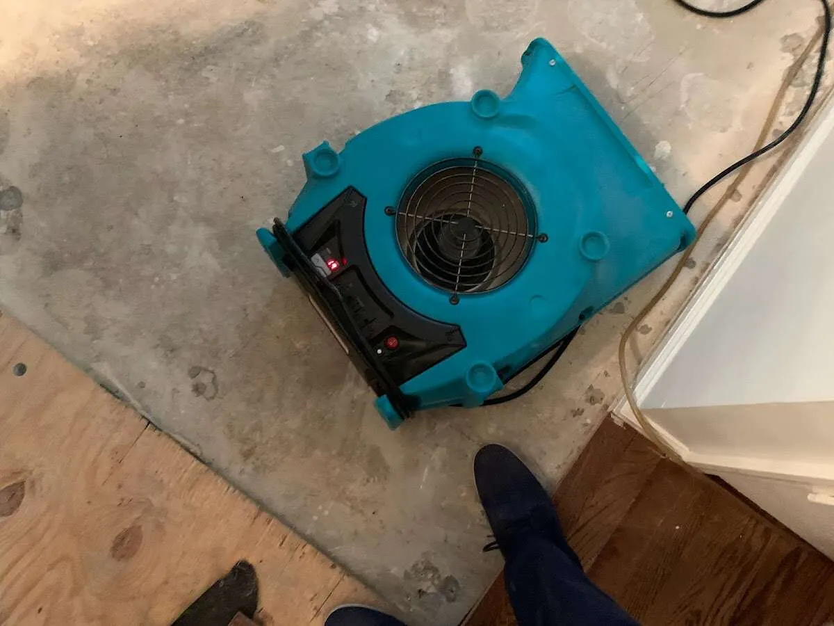 Air mover drying subfloor during Commercial Water Damage Restoration in North Londonderry